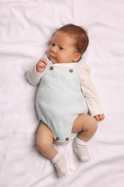 istock Cute newborn baby lying on white blanket, top view 1935734062
