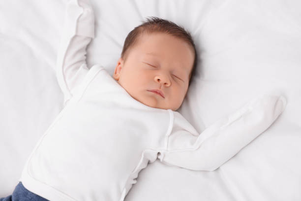 istock Cute newborn baby sleeping on white blanket 1935734577