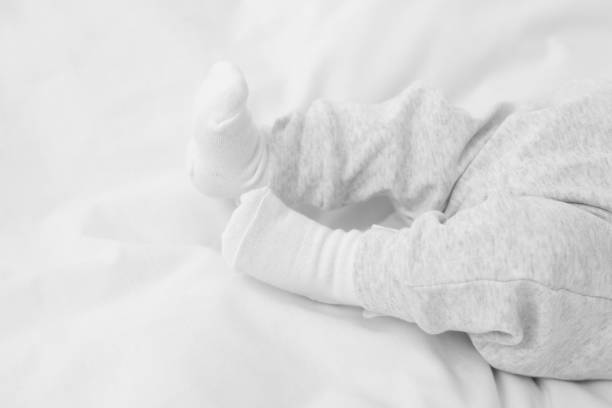 A caucasian newborn baby lying on his back. Mid shot