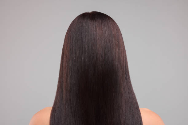 istock Woman with healthy hair on grey background, back view 1935744940