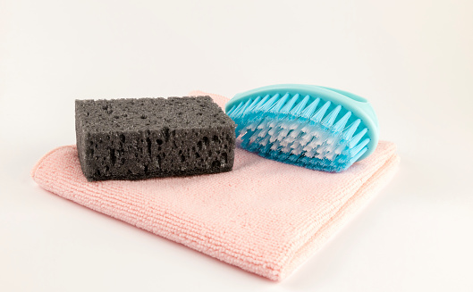 Clean sponge brush and rag. Cleaning rags on a white background. Tools for washing dishes