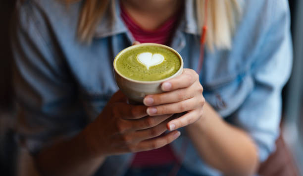 Anonymous Young Woman Enjoys Drinking Delicious Matcha Tea With Green Foam