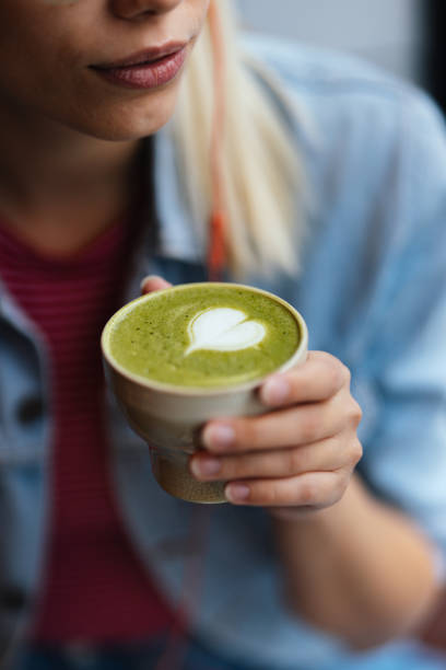 istock Anonymous Young Woman Enjoys Drinking Delicious Matcha Tea With Green Foam 1935765355