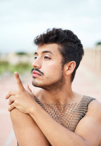 Non-binary person posing looking to the side. Concept of LGBTIQ community.