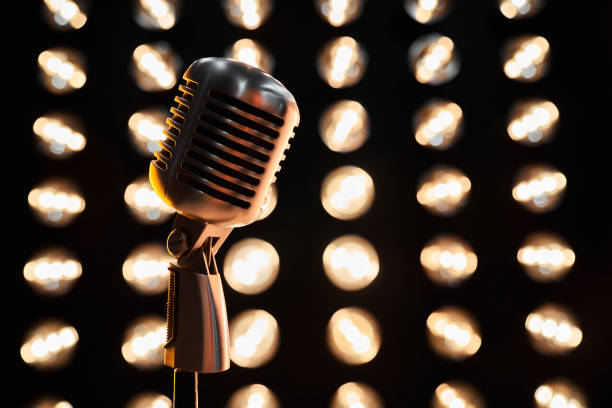 istock Vintage mic against dark sparkling bokeh backdrop. 1935804079