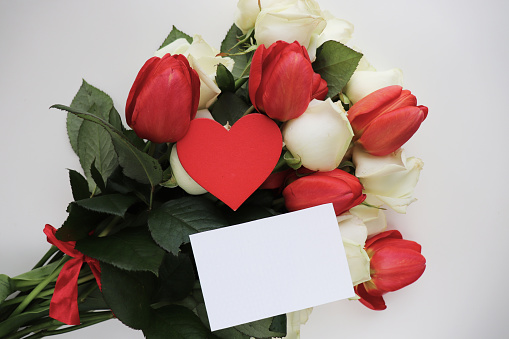 bouquet of flowers and red heart valentine