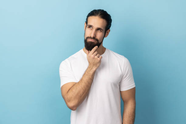 istock Man holding his chin and pondering idea, confused not sure about solution. 1935826235