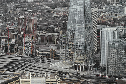London Bridge Station, The City of London, England, United Kingdom, Great Britain - 8th of January, 2024: An aerial photo shot presents an awe-inspiring panorama of The Shard, The News Building, and the United Kingdom's capital city, London, in broad daylight. 

The urban landscape of London City.