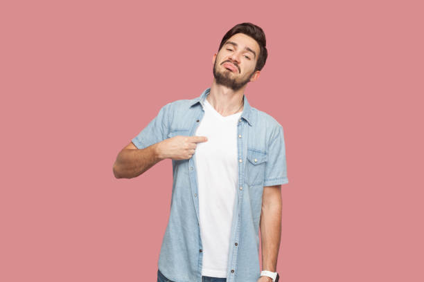 istock Satisfied proud bearded man in blue shirt standing points at himself, stands self confident. 1935844268
