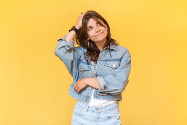 istock Puzzled uncertain woman rubbing her head, thinking, having thoughtful pensive expression. 1935859409