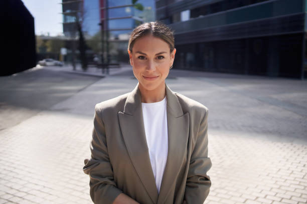 istock Attractive professional successful female suit posing in confident attitude outside office center. 1935859923