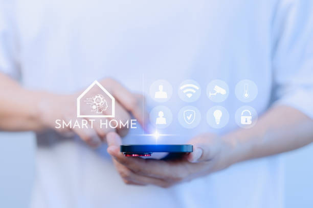 istock Adult man control technology AI smart home devices using a smartphone or mobile phone with launched application. Internet of Things of smart home automation apps concept. 1935863894