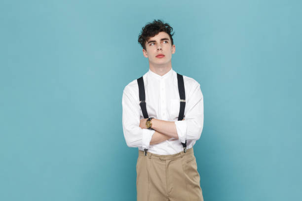 istock Handsome pensive thoughtful man crossing his hands and looking away, thinking. 1935867254
