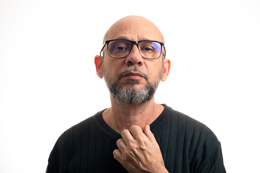 White man, bald, with prescription glasses looking at the camera against white background.