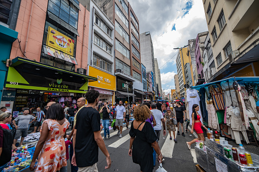 Crowd of people and shops on a street in the market disctict near the historic cnetro, São Paulo, Brazil
