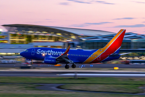 Portland, Oregon, USA - October 7. 2023: A Southwest Airlines Boeing 737 takes off, just after sunset, from Portland International Airport.