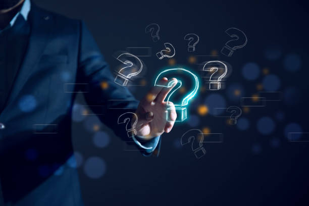 istock Businessman with question marks in his hand 1935903916