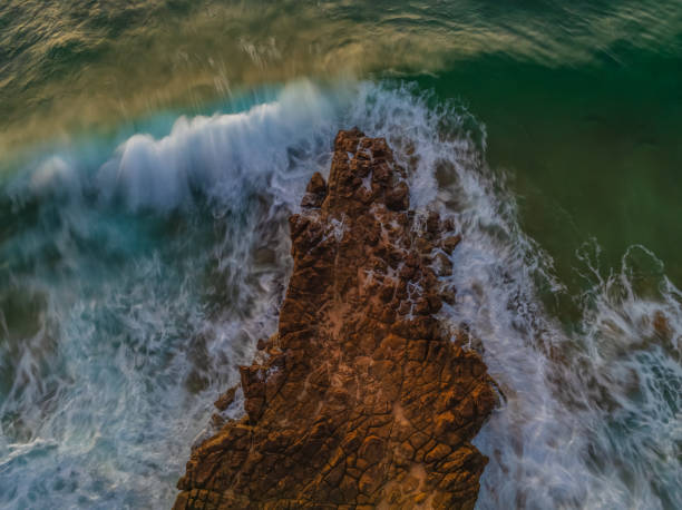istock Top down sunrise over the sea and rock platform 1935950651