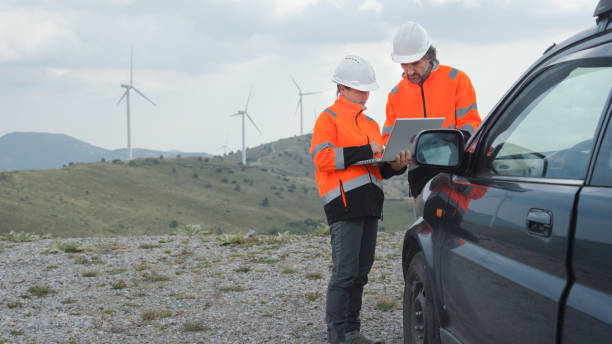 istock Wind energy engineers working in wind turbine farm. 1935984941