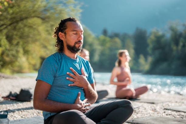 istock Hispanic Male Meditating by the River 1935986036