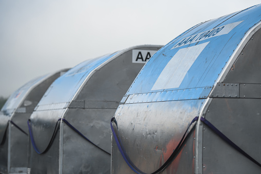 Containers on a loading truck ramp at the airport.