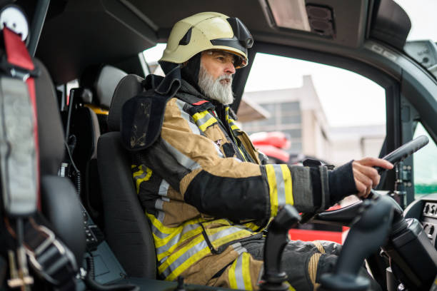 istock Senior Caucasian Firefighter Driving A Firetruck 1936016907