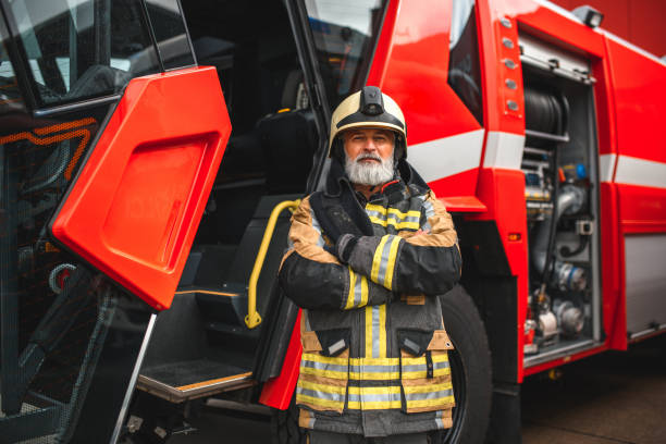 istock Firefighter Standing Next To A Fire Truck With hands Crossed 1936016919