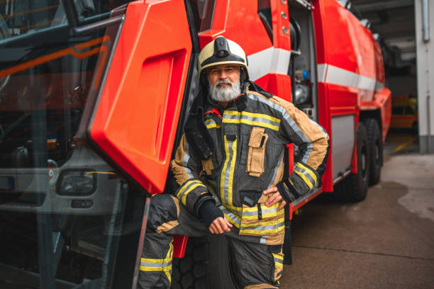 istock Firefighter Standing Next To A Fire Truck 1936016937