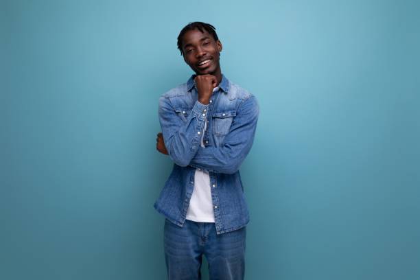 istock well-groomed brunette man with dreadlocks in a denim jacket 1936018042