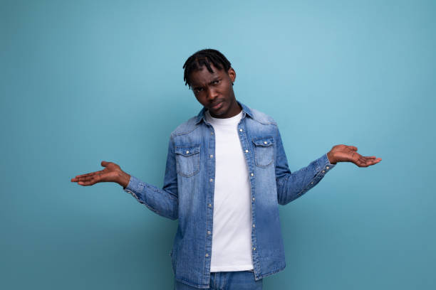 istock upset african man with curly hair in denim jacket 1936018044