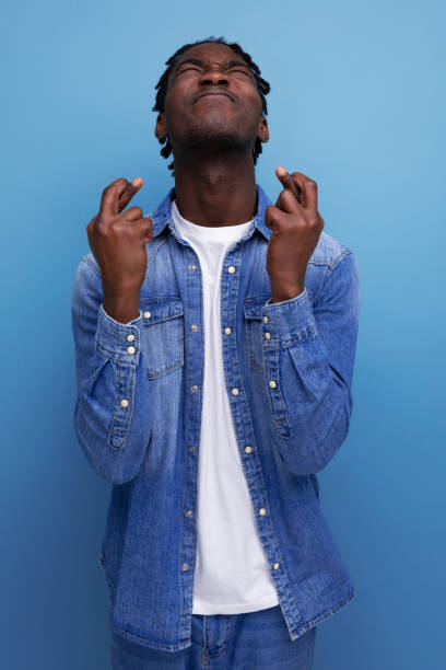 istock portrait of a young cheerful american man with dreadlocks in a denim jacket who screwed up 1936018564