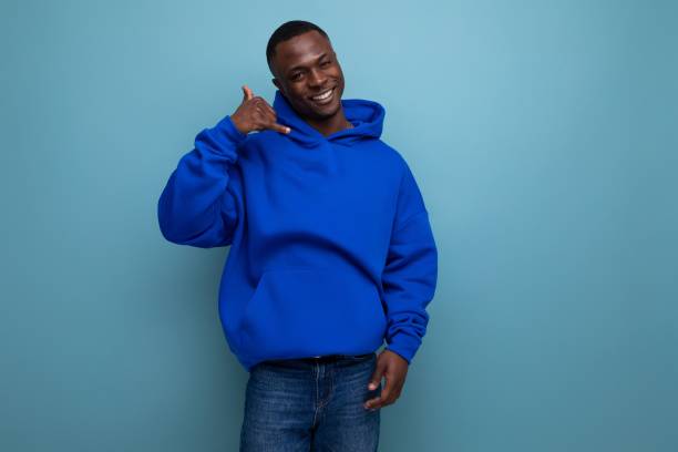 istock friendly dark-skinned young american man in blue sweatshirt on studio background with copy space 1936019155