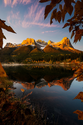A fine art landscape photography image of Spray Lakes in Canmore Canada during a vibrant Autumn sunrise with alpine glow