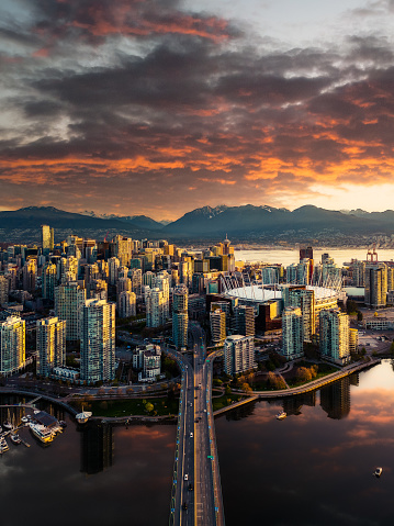 A fine art landscape photography image of the downtown Vancouver skyline from a done during a fiery and dynamic Spring sunrise.