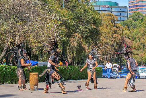 Mexico City, Mexico. Jan 11, 2024. A group of individuals, descendants of the Aztec culture joyfully dance to celebrate their heritage outside the Anthropology Museum in Mexico City