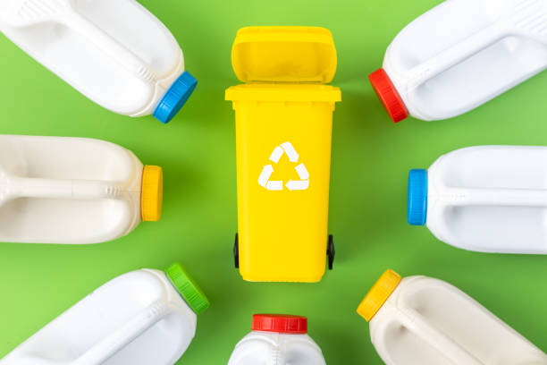 istock Segregation of plastic waste, garbage can and plastic bottles on a beautiful green background, environmental concept 1936105899