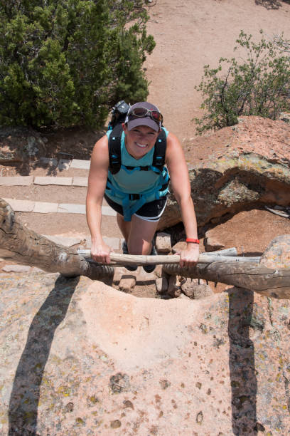 istock Woman Climbing Ladder in Bandelier 1936126204