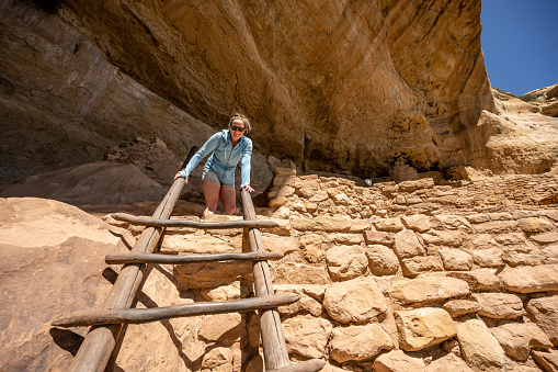 Woman Looks Down From Top Of Ladder In Mesa Verde National Park