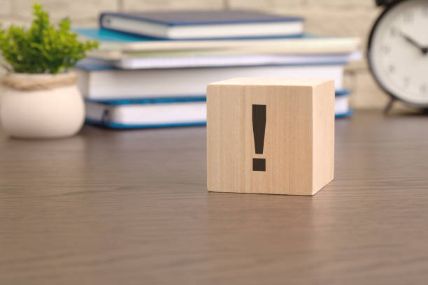istock exclamation mark written on wooden cube lying on table, business and education concept. close-up cubes 1936132161