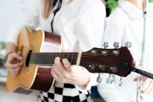 Beautiful young asian woman playing acoustic guitar . fashion lifestyle