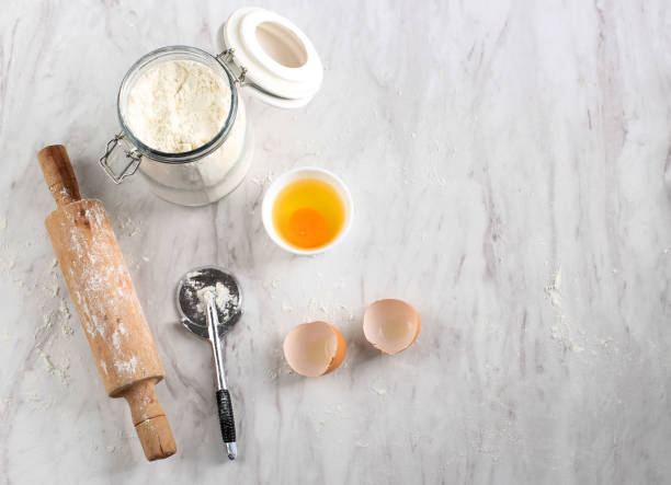 istock Messy Kitchen, After Baking Preparation at Marble Table. Flour, ROlling Pin, Egg, Pizza Cutter with Copy Space for Text 1936211676