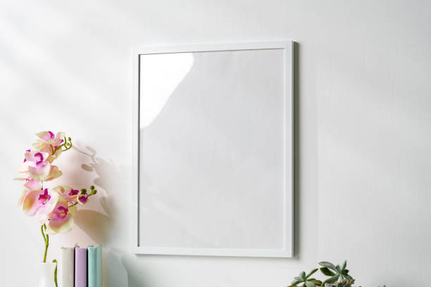 istock White wooden frame on white wall above the table 1936225644