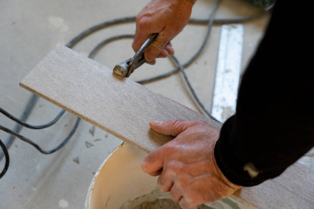 istock Laying ceramic floor tiles, the process of cutting tiles 1936227748