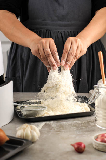 istock Female Home Chef Making Homemade Crispy Fried Chicken, Coating Chicken Drunsticks with Flour in the Kitchen 1936240026