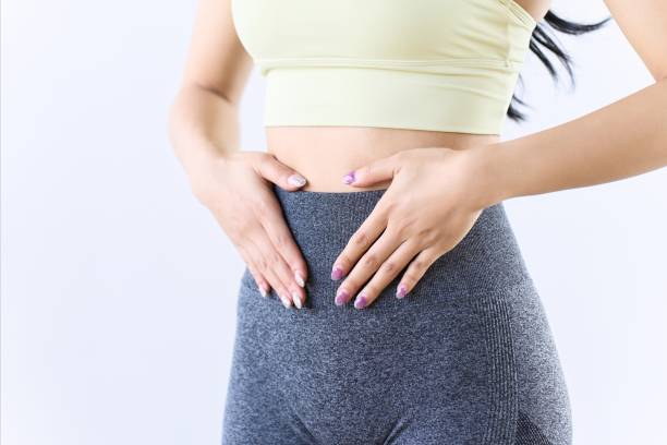 a woman suffering from stomach problems - 腸 ストックフォトと画像