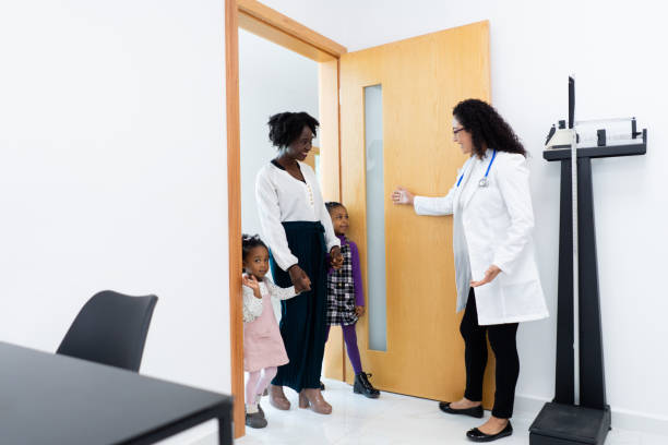 istock Female doctor warmly welcomes young patient 1936270164