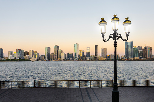 Beautifyl view of waterfront downtown of Sharjah, UAE at sunset. The cultural capital of the UAE.