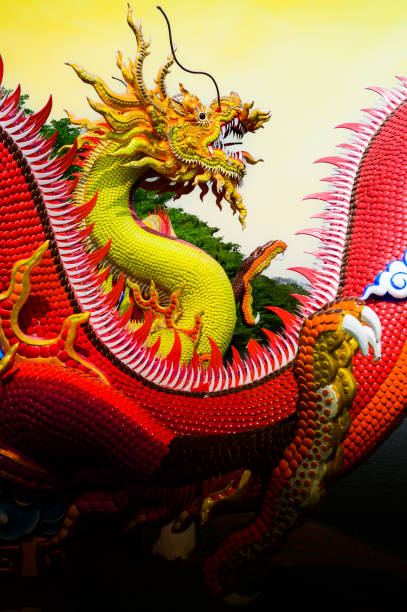 istock Yellow dragon statue with yellow sky background 1936319695