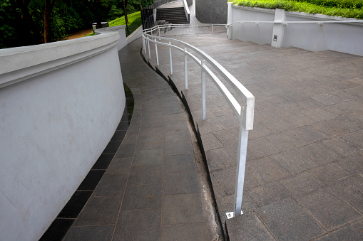 Staircase down with white handrail on the park