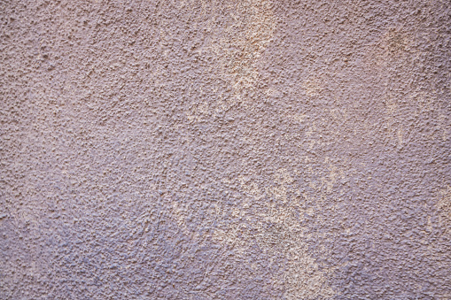 Abstract stucco background texture with variations in the color